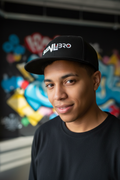 Close-up of person wearing SNLB Cap - graffiti background